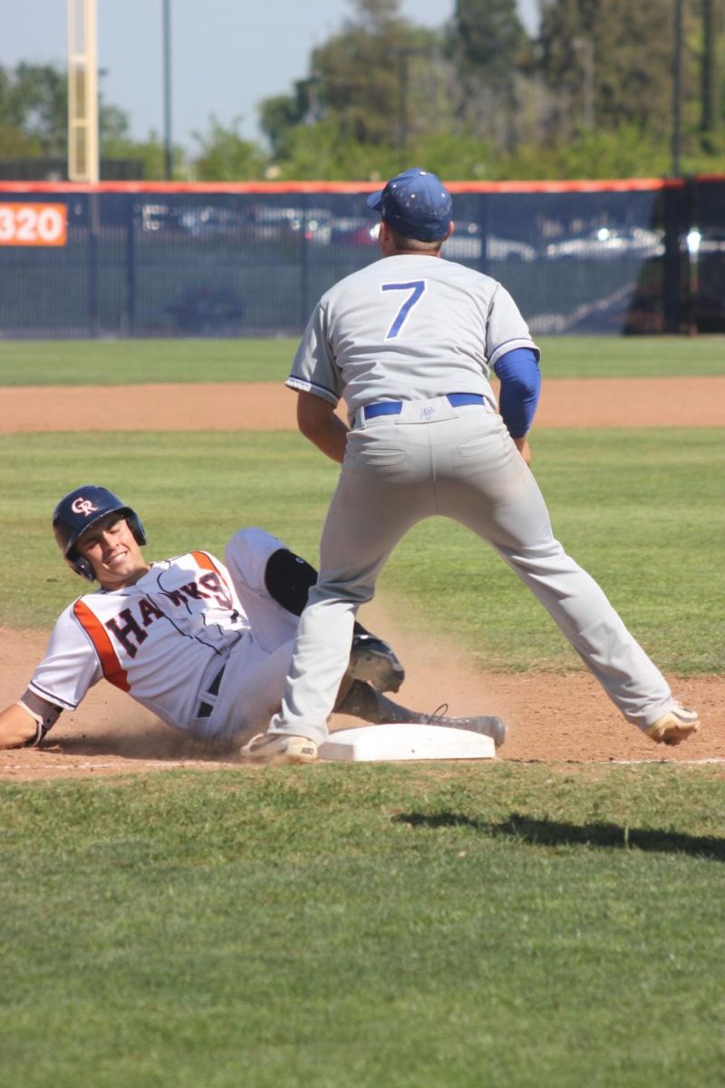 Infielder Alex Crouch slides to third base after hitting a triple for 360 ft into midfield. This play allowed utility Greg Creamer and first baseman/left hand pitcher Joey Pankratz to score on a double RBI, and the score was 5-0 in the bottom of the third inning on Tuesday.