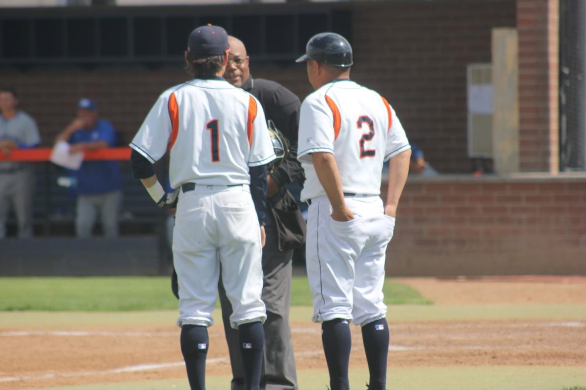 JD Mico, on the left, and Don Mico talking to the umpire during the game versus  Modesto Junior College on April 27.