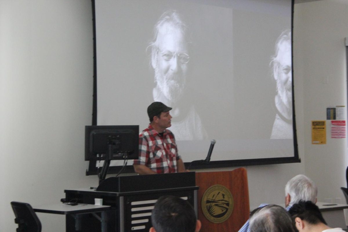 CRC student Doug Winter gives a speech about homeless people's lives to a crowd of people in the WINN Center. 