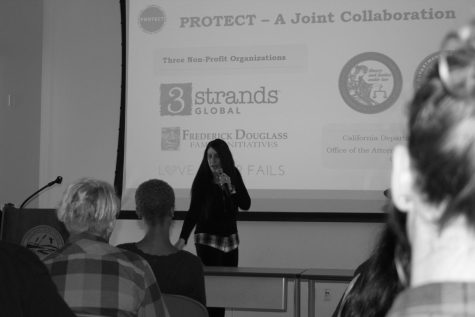 3Strands Global spokesperson Melissa Zapata gives a speech about human trafficking to a group of people in the WINN Center.