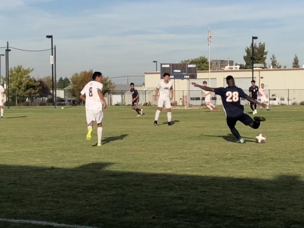 Forward Jubilee “DJ” Emojong passes the ball to the middle during their match against American River College on Friday.  Emojong was later ejected for fighting near the end of the Hawks 3-1 loss to the Beavers.