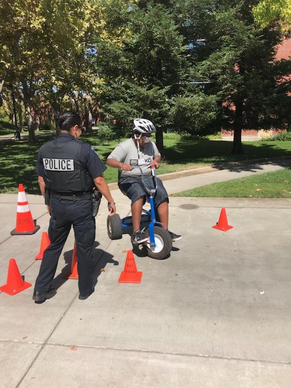Police officer Rosie Salazar watches over Roman Sotelo, 18, as he participates in a drunk driving obstacle course near the LRC Center.
