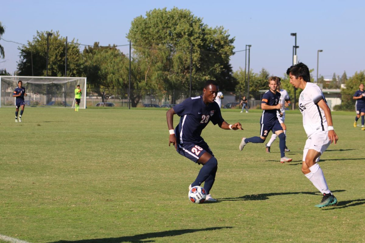 Freshman forward DJ Emojong uses some fancy footwork to advance the ball upfield. Emojong is one of 20 freshman who hope to return next year and push for a state title.