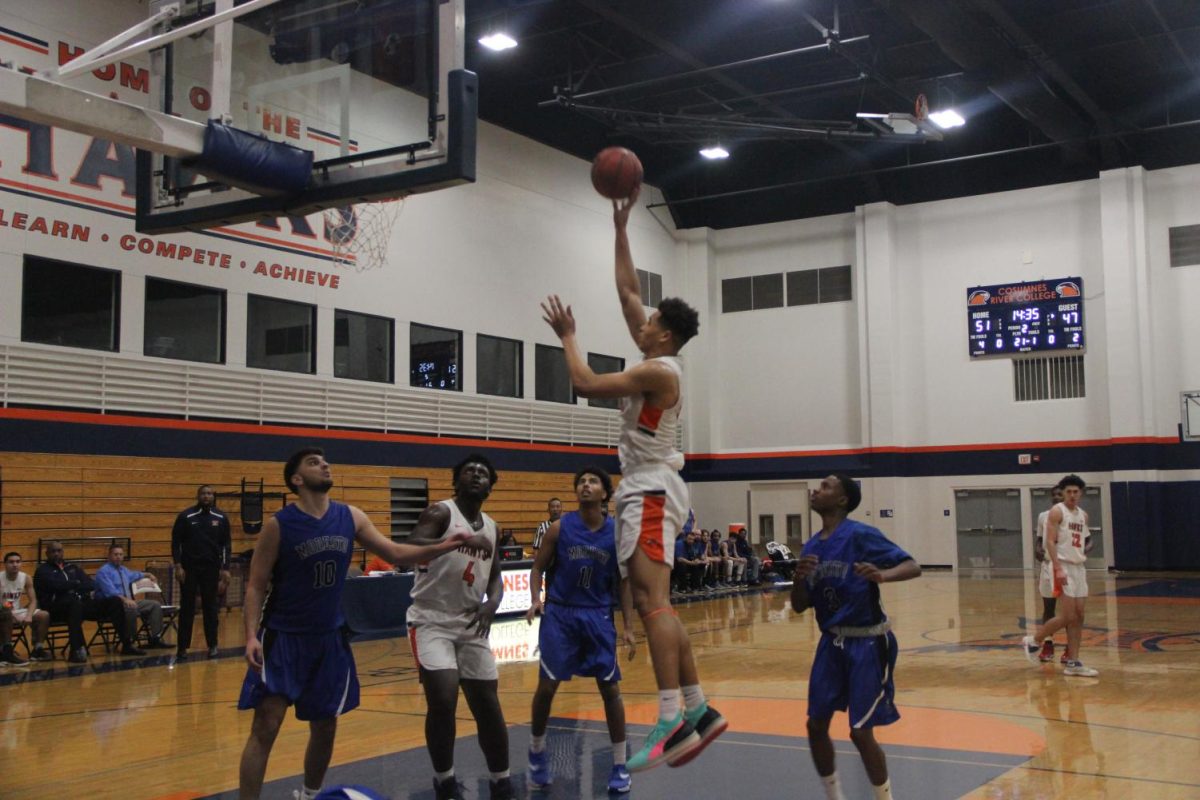 Sophomore forward Drew Buggs goes for a turnaround hook shot after a pump fake on Tuesday against Modesto. Bugg's 17 points helped the Hawks get a much needed win as they fight for a playoff spot. 