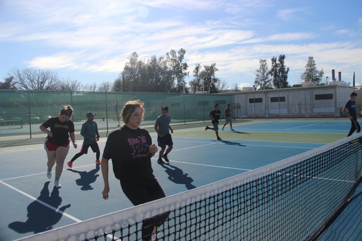 The Hawks' tennis teams practice together. The teams said condition would be a key factor to a successful season.