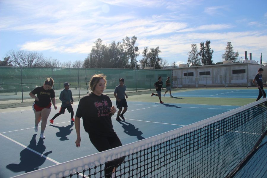 The Hawks tennis teams practice together. The teams said condition would be a key factor to a successful season.