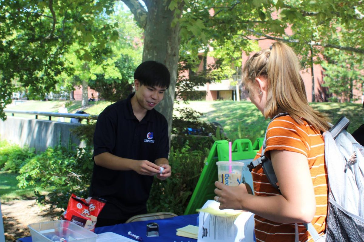 ASCRC Senate President Jonathan Leong talks to a student.