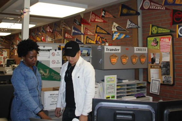 Transfer Center Clerk Channing Corbin helps a student by making sure he has all the required documents for his UC application. The Transfer Center is located in L-217 and is open from 8 a.m. to 4:30 p.m. Monday through Friday.