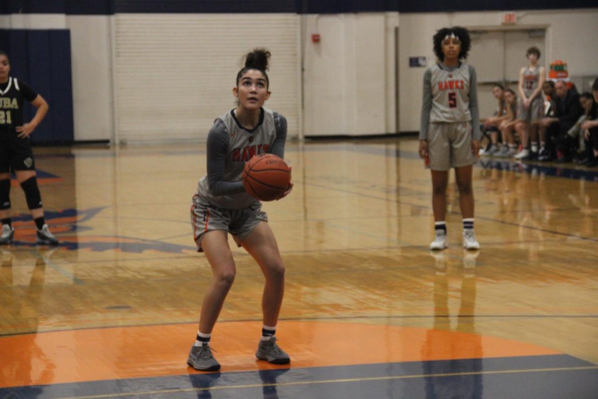 Sophomore guard Arionna Butts gets ready to throw a free throw from the goal line during their game with Yuba College 49ers. The game, which took place on Tuesday, resulted in a 3-6 loss for the Hawks. 