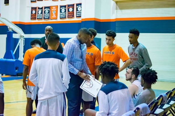 Men’s Basketball Coach Jonathan James diagrams a play for his team during a timeout in Jan. 2018. Because of COVID-19, fall sports have officially been pushed back to the spring season. 