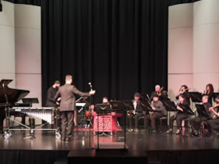 Music Professor Maxwell Kiesner conducts the campus orchestra during the Student Spotlight. The event was held on Thursday in the Recital Hall.