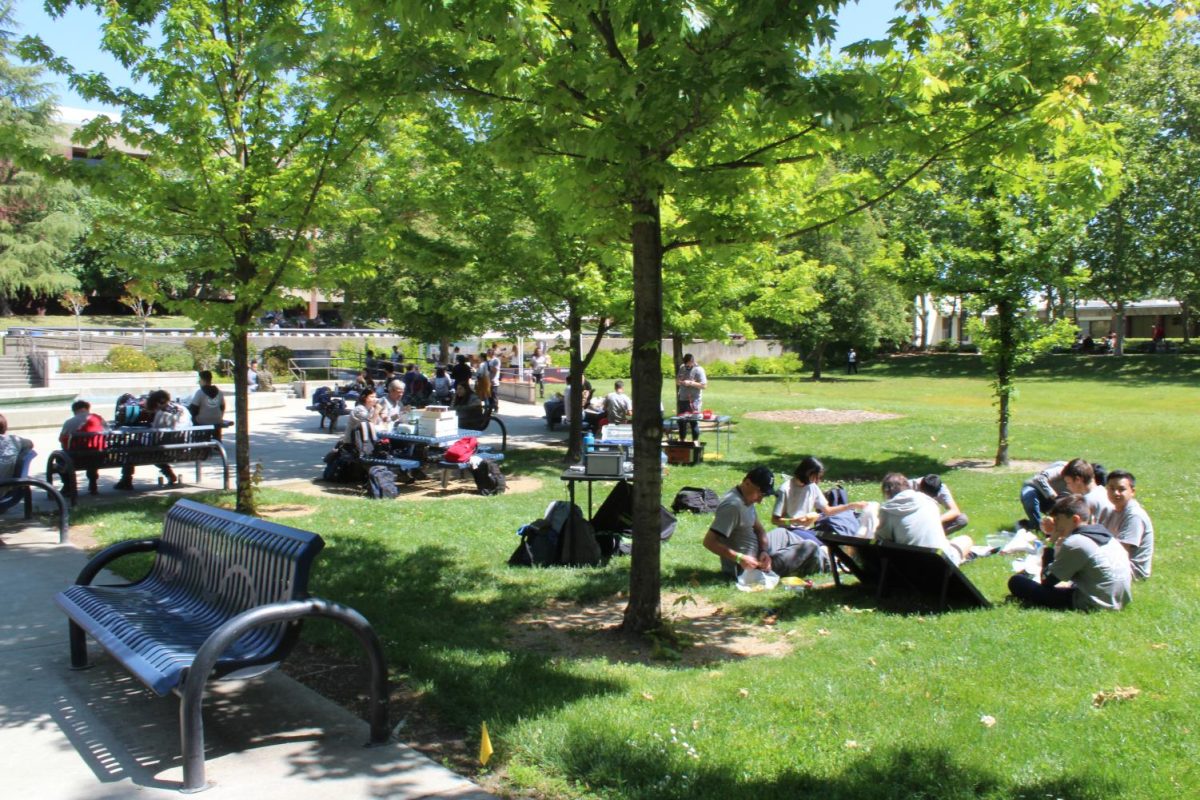 High school students attending the Earth Day celebration. Attendees could explore booths hosted by the architecture program at Cosumnes River College, the Sacramento Electric Vehicle Association and SMUD.