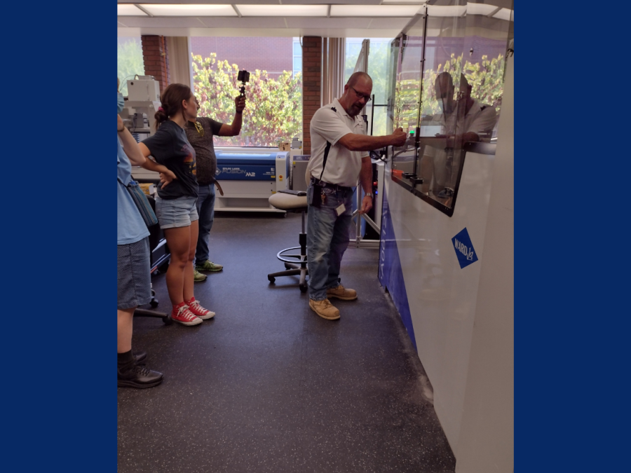 A hybrid workshop was held on Thursday to introduce a new facility called the CRC Makerspace, which has advanced manufacturing equipment. Construction Professor Ryan Connally gives a tour of the CRC Makerspace and he is showing the attendees the waterjet machine.