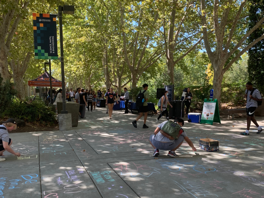 Students walking around the resource fair, interacting with the information booths.