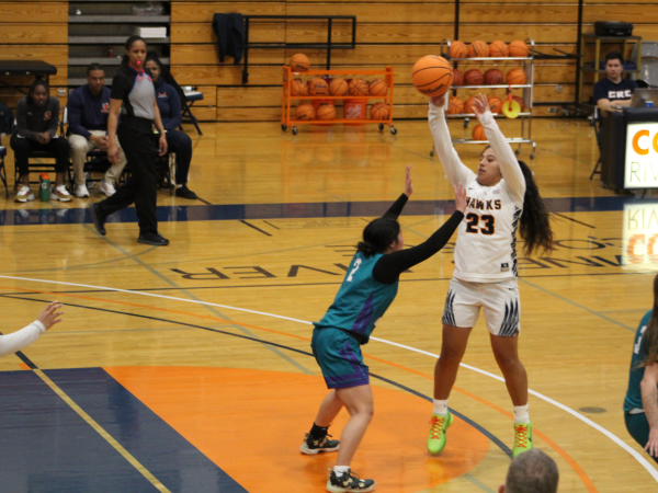 Freshman point guard and co-captain Ashley Gonzalez attempting a pass during the Friday matchup against Folsom Lake College. The womens basketball teams final home game of the season ended in a loss with a score of 67-50.