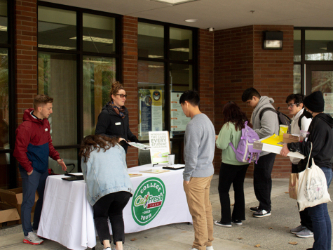 The CalFresh program held a table by the cafeteria on Thursday to inform students about their program. CalFresh Event Manager Jansen Engelbrecht (left) and CalFresh Event Representative Erin McMichael (right) giving information about the program to students.