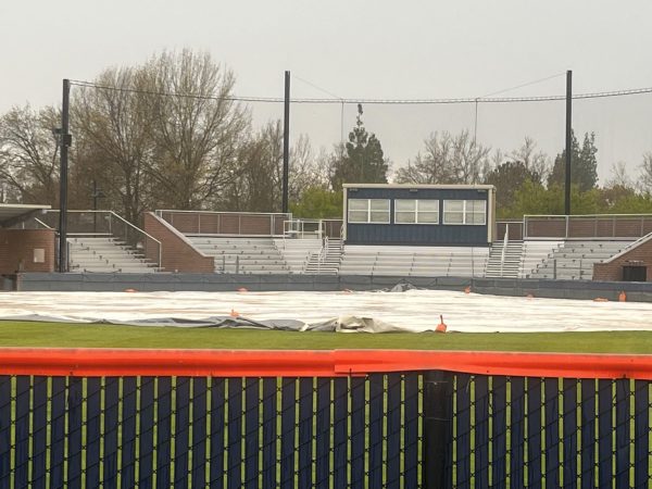 The Hawks softball team set up the tarp to protect their field from the rain on March 29. Due to the rain, this has become a regular occurrence for all outdoor sports teams at CRC in order to keep it dry for game day.