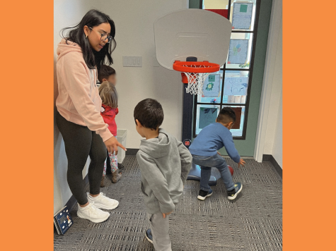The Nest Support and Coaching Specialist Emely Salgado at the event with the kids on March 23 in the Child Development Center. Salgado is helping teach kids how to play basketball.