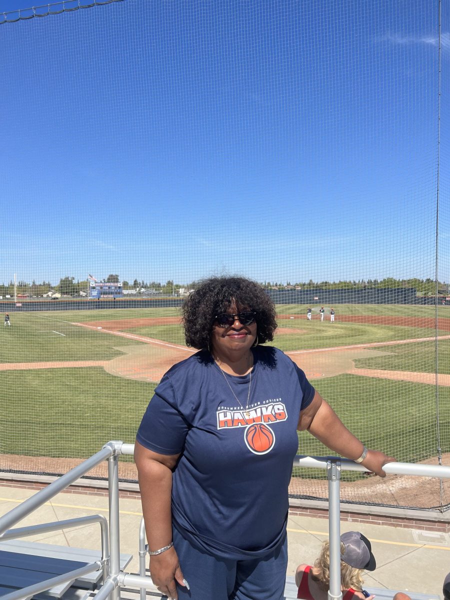 Deedria Clark-Peeler at a men's baseball game. Clark-Peeler is the daughter of James "Gym" Clark and the official stat-keeper for Cosumnes River College.