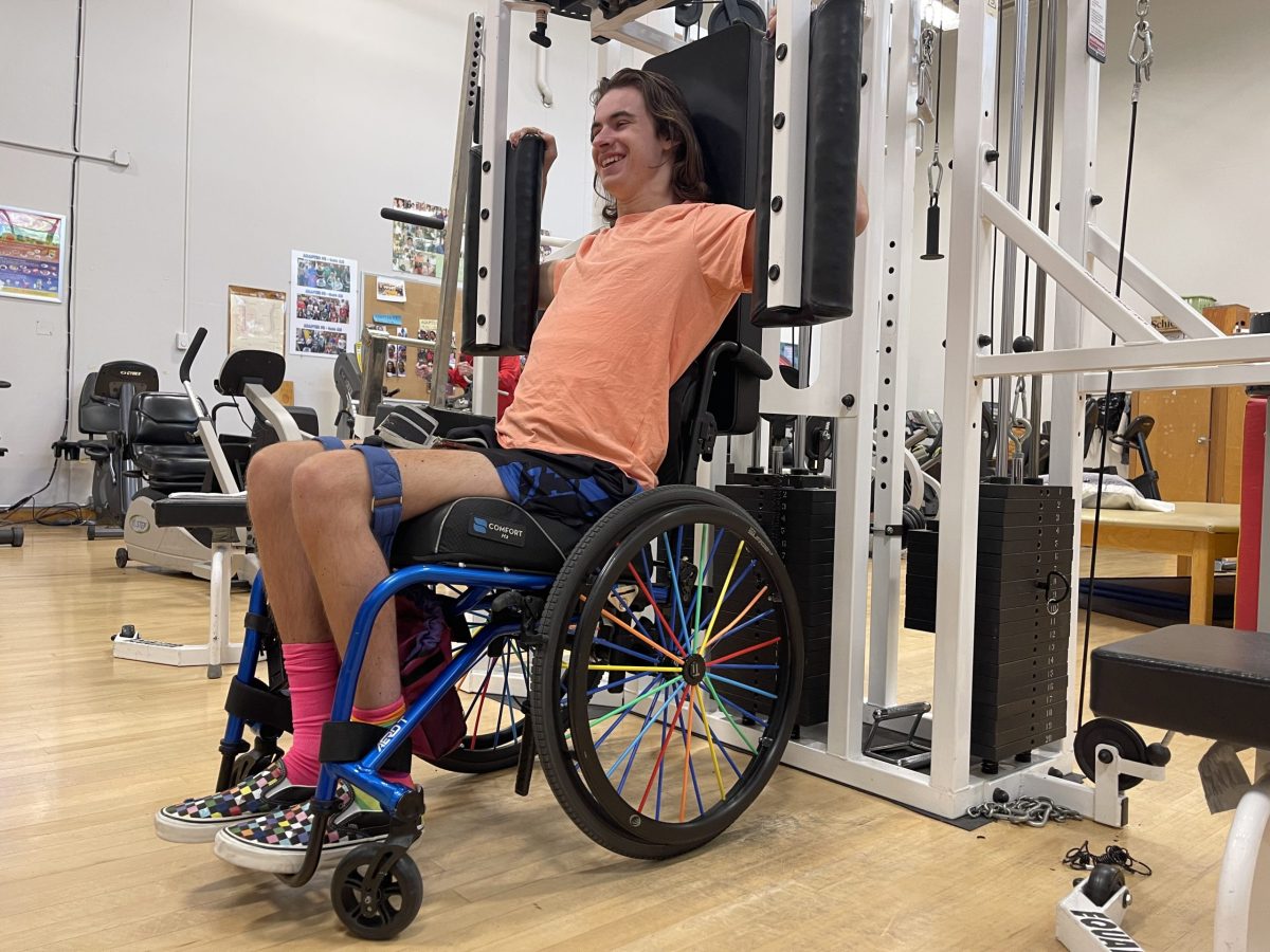 Biology major Ricky Pool, 19, using an equalizer modular weight station during class. This is Pools third semester in the adaptive fitness class.