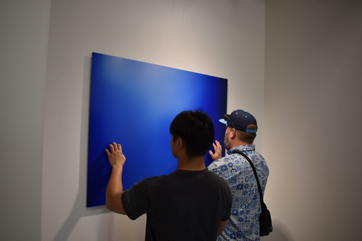 People+interact+with+Color+Number+3+made+by+Doug+Winter%2C+a+photographer%2C+to+convey+the+color+blue+by+way+of+touch.+The+art+exhibit+Echoes+of+Perception%3A+Essays+on+Vision+is+open+until+Nov.+16+in+the+Art+Gallery.