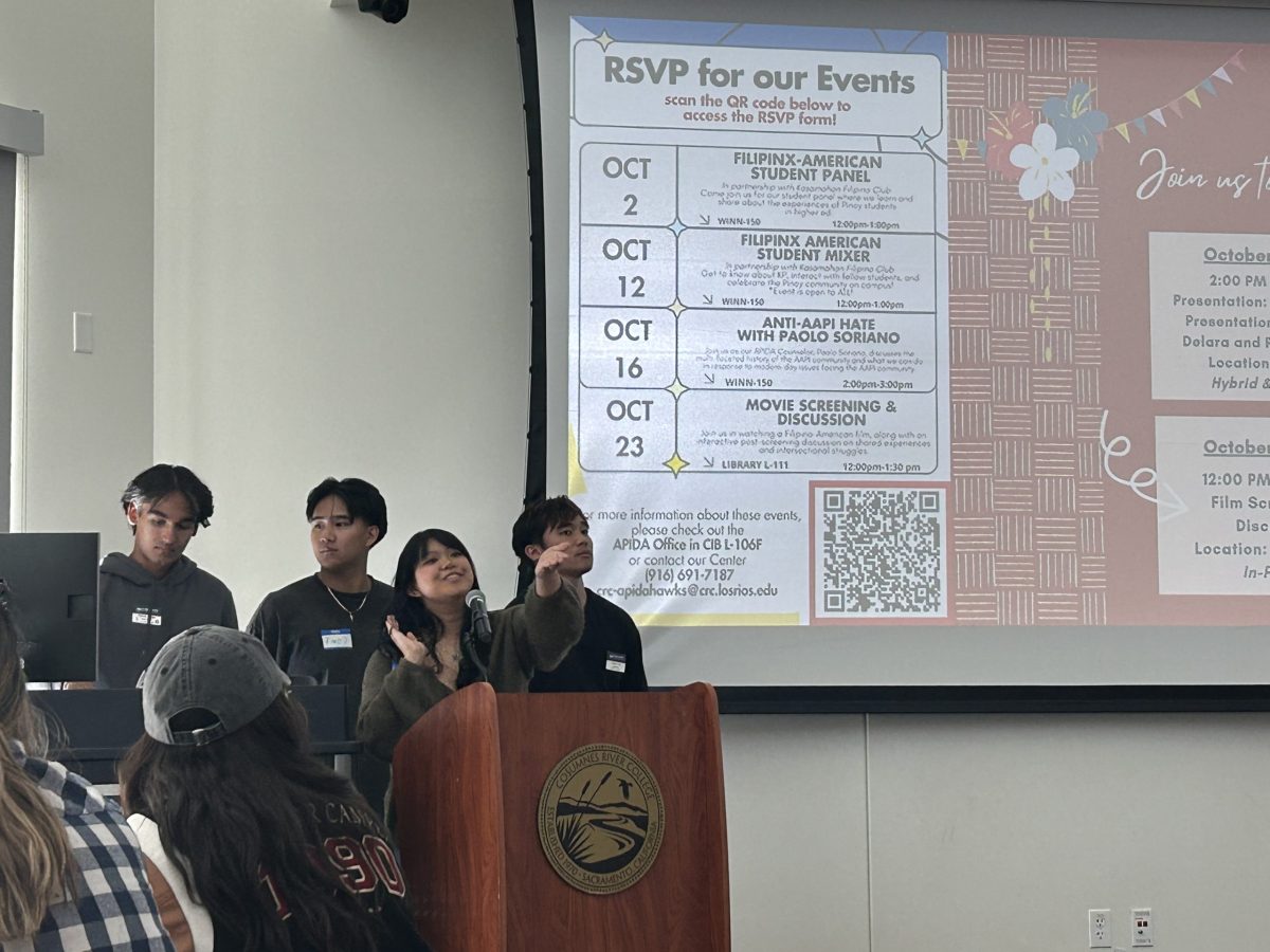 Kasamahan Pilipino Club President Alyanna Manzano (front) showcases events for October's FilipinX History Month. The club hosted an event with traditional food and karaoke on Oct. 12.