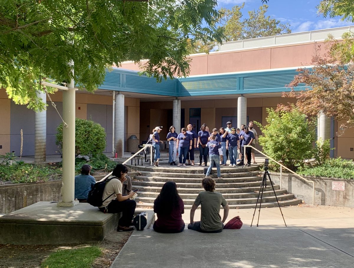 Music Professor Omari Tau leads the Contemporary Gospel Choir in a preview concert on Tuesday. The concert took place in the AME quad and was  presented by CRC's Music Department to promote one of their many live events that week.