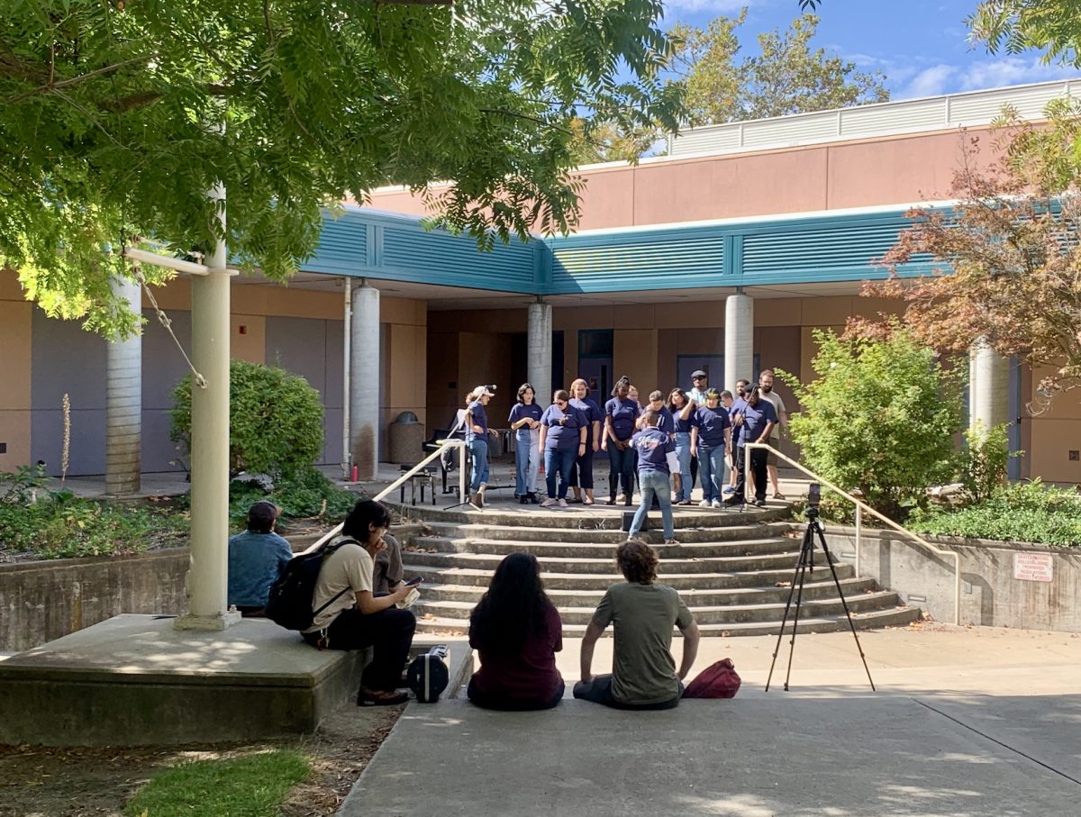 Music Professor Omari Tau leads the Contemporary Gospel Choir in a preview concert on Tuesday. The concert took place in the AME quad and was  presented by CRCs Music Department to promote one of their many live events that week.