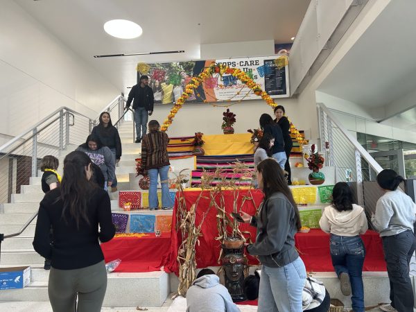 Puente and MI CASA students add offerings to the altar to celebrate Día de Los Muertos on Oct. 31. Día de Los Muertos, or Day of the Dead, is celebrated in Mexico to honor family and friends who are deceased on Nov. 1 and 2.