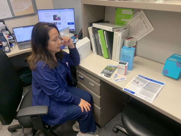 College Nurse Michelle Barkley in her office on Monday looking over a harm reduction kit offered to students that includes Narcan nasal spray. In 2024 the kits will include fentanyl testing strips as required by AB 461.