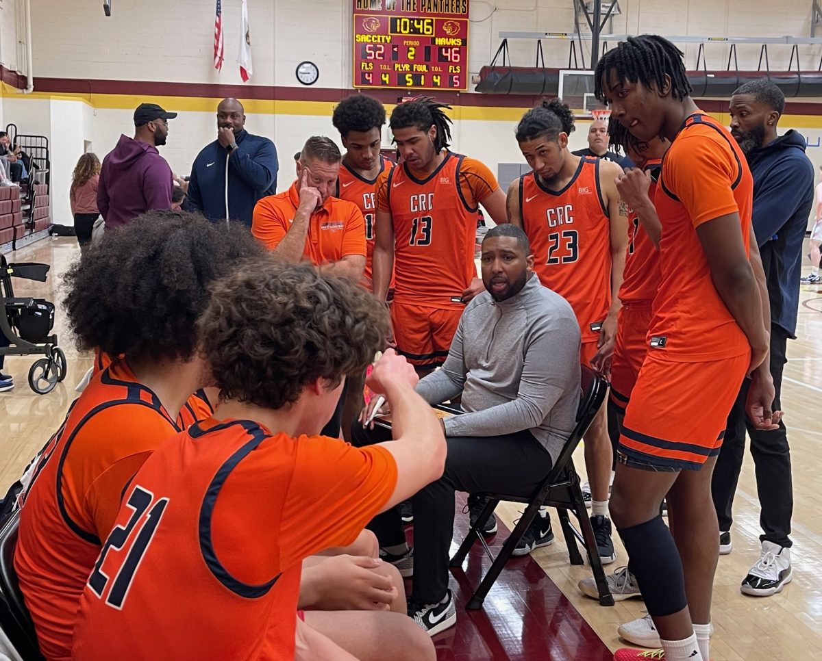 Head Coach Jonathan James (middle) talks to the Hawks at Sacramento City College during a timeout early in the second half of their game against the Panthers on Jan. 12. The Hawks play conference opponents on the road for their next four games starting with the Diablo Valley College Vikings on Tuesday.