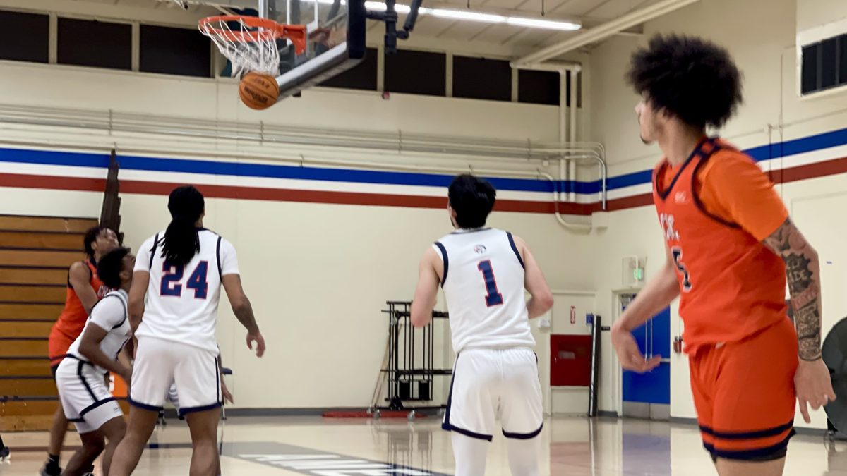 Guard Isaiah Griffin (right) stares down his basket against the American River College Beavers in the Hutchinson Gym at ARC on Jan. 26. The Hawks beat the Modesto Junior College Pirates 72-59, ending their stretch of five consecutive away games on Jan. 30.