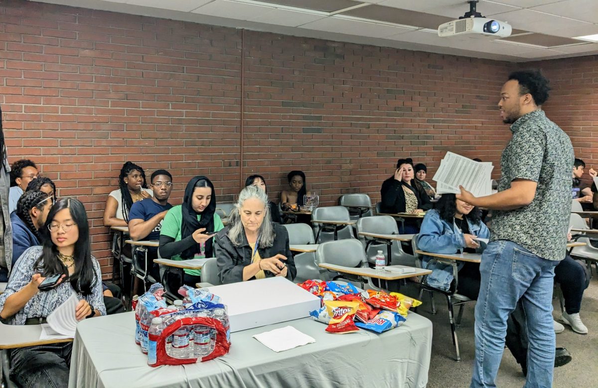 Therapist intern Demond Washington hands out a “Childhood Experience Questionnaire for Adults” for students to fill out during a workshop addressing trauma on April 3. The hosts and students discuss results of the questionnaire and normalized traumatic childhood experiences.
