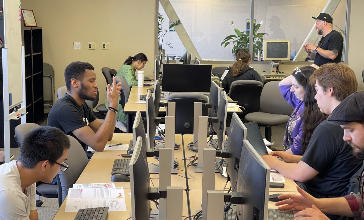 Students participate in the Drop a Pen creative writing workshop, hosted by 916 Ink, a Sacramento non-profit committed to empowering youth through literature. Sacramento Poet Laureate Andru Defeye, the official poet of Sacramento (right), stands and talks to students about the project. 