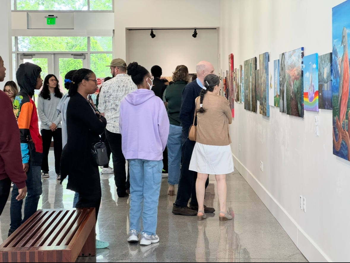 Spectators admire student's artwork along the walls of Cosumnes River College's Art Gallery during the Annual Student Juried Art Exhibition on Thursday. Student's have the opportunity to have their work purchased from the gallery until the exhibit closes on May 15 and receive 100% of the proceeds. 