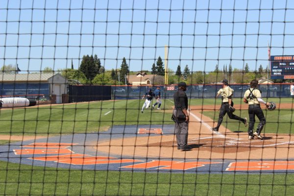 Sophomore center fielder Chase Christenson scores the first run of the game on April 8 in the first inning. The Hawks went on to win the series against the Mustangs, 2-1.