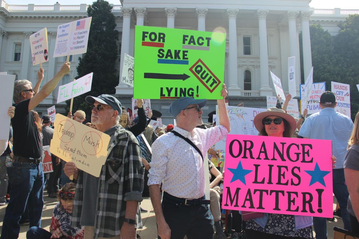 Demonstrators holding signs in front of the Sacramento Capitol located on 10th street. Thousands of demonstrators protested policies instituted by Trump and Elon with signs, chants and by listening to speakers. 