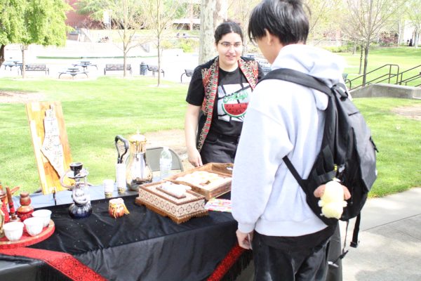 The student tabling the Palestine table is sharing date cookies, baklava and Arabic coffee. The event was thrown on by the APIDA Hawk center to bring awareness to other students about Eid.