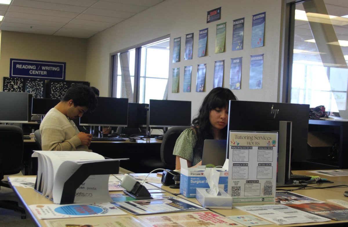 Lily Muñoz, a front desk staff member, at the entrance of the Reading and Writing Center. The hiring process was delayed for about a week due to financial aid freezing funds.
