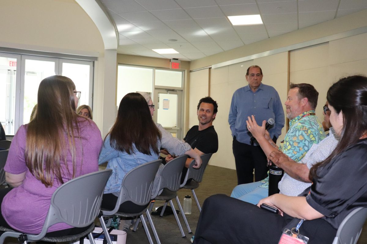  Brian Rickel, the dean of arts, media and entertainment, speaking at the chancellor search in WINN 150 on May 7. Rickel said he would like to see a chancellor who puts a bigger emphasis on the arts in education. 