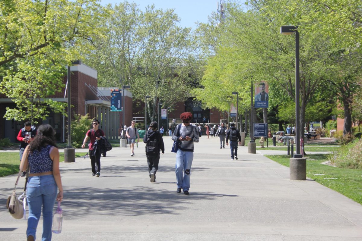 Students walking on the pathway near the south entrance of campus, five years after COVID-19. During COVID-19, the Center for Disease Control and Prevention implemented social distancing and a mask mandate, according to the CDC website. 