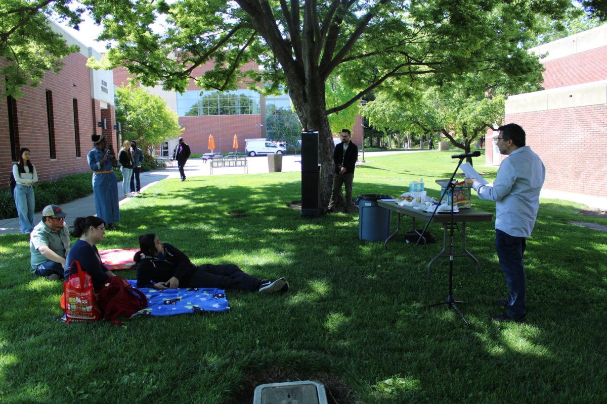 English Professor David Weinshilboum sharing one of his favorite poems during the poetry picnic. The event had food, drinks and there were prizes that were won by the participants for the picnic. 