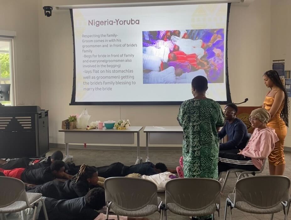 Attendees recreating a Yoruba tradition on April 29. In this tradition the groom and his groomsmen lay on their stomachs in front of the bride’s parents, in order to get their blessing and respect. 