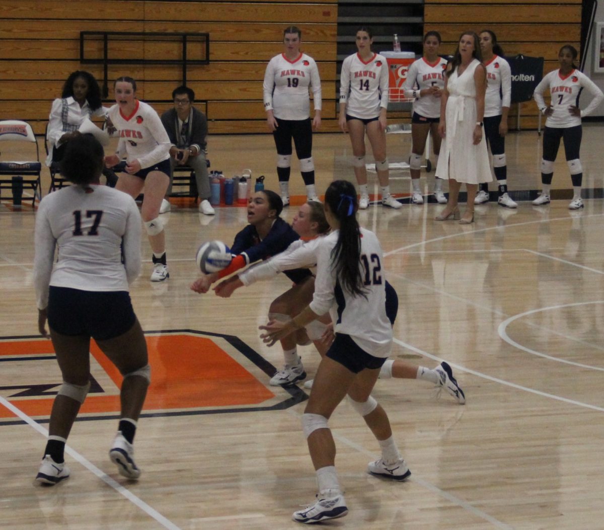 Freshman defensive specialist Emmerson Patterson receiving a serve from the opposing team. Patterson led the game with 25 digs as the Hawks opened conference play with a 3-2 win.