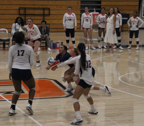 Freshman defensive specialist Emmerson Patterson receiving a serve from the opposing team. Patterson led the game with 25 digs as the Hawks opened conference play with a 3-2 win.