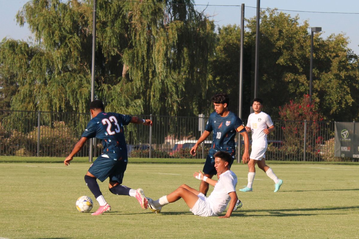 Freshman defender Meyoune Bayless and sophomore midfielder Michael Villasenor protect the ball from Lemoore on Friday. The Hawks secured a win without allowing Lemoore to score.