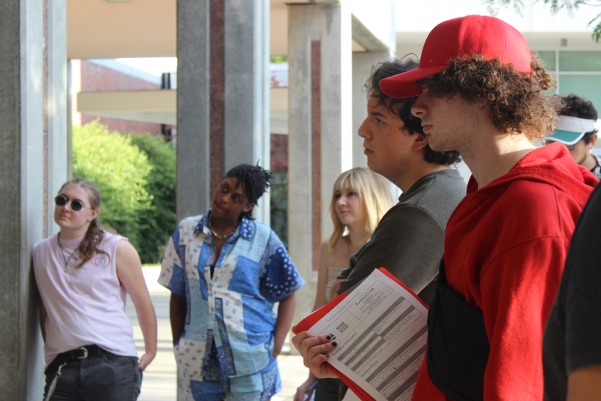 Students listen as directors address them outside the Black Box Theatre before auditions on Sept. 8. “It was really fun to see so many students come out and be interested in performing,” said “Birdmocking” director Matthew Miller.