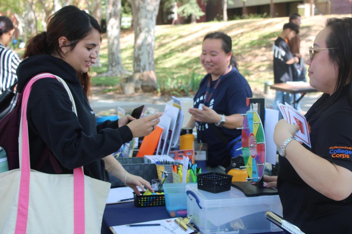 The campus Success Coaches hand out free school supplies and tips on how to make studying on campus easier. They were one of 24 organizations and clubs tabling by the fountain quad as part of Hawk Days on Tuesday and Wednesday.