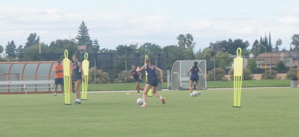 Some of the players performing a passing drill during Wednesday’s practice with head coach Cesar Plasencia in the background. The Hawks kick off conference play on Friday at home against Solano Community College.