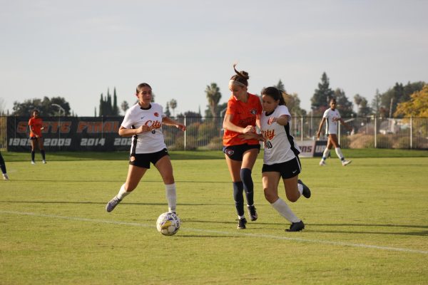 Sophomore midfielder Anisa Gonzalez fighting the Sacramento City College player for the ball during Tuesday’s playoff. They tied 2-2 before the Hawks won in penalty kicks against the Panthers 4-3.
